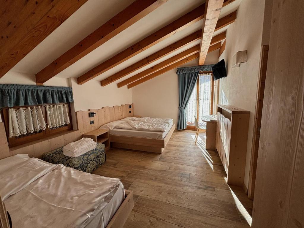 Postel nebo postele na pokoji v ubytování Residence Cima Tosa