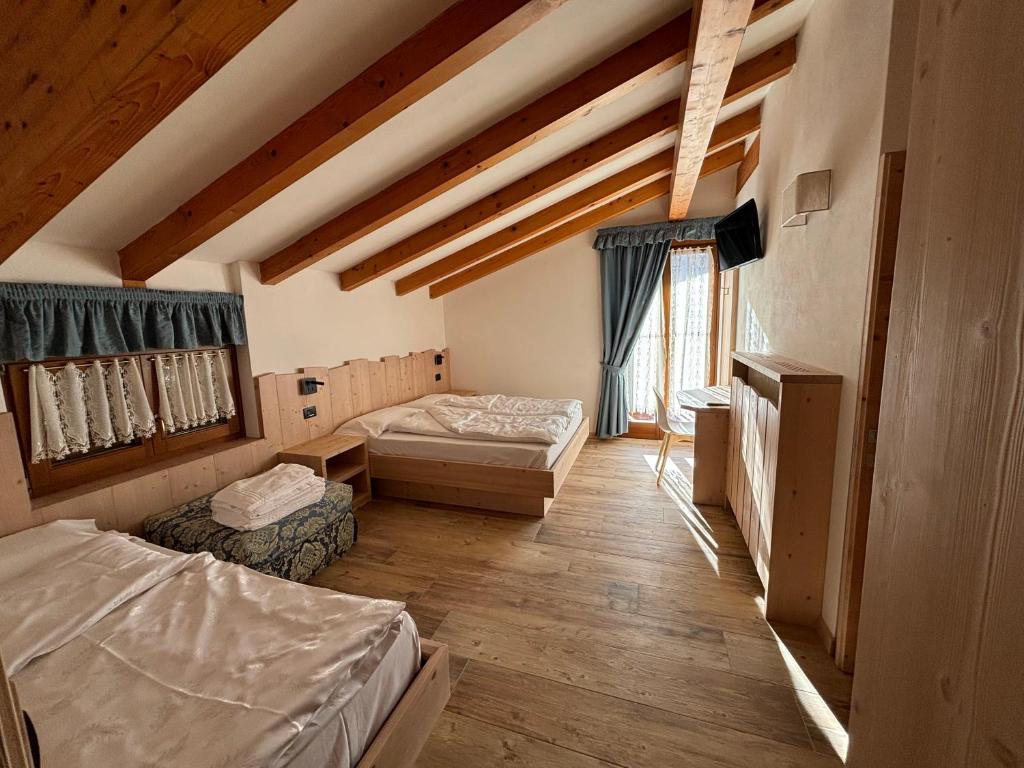 Postel nebo postele na pokoji v ubytování Residence Cima Tosa
