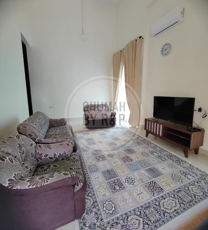 a living room with a couch and a flat screen tv at Ghumah by R&P (near Hospital Sultanah Bahiyah) in Alor Setar