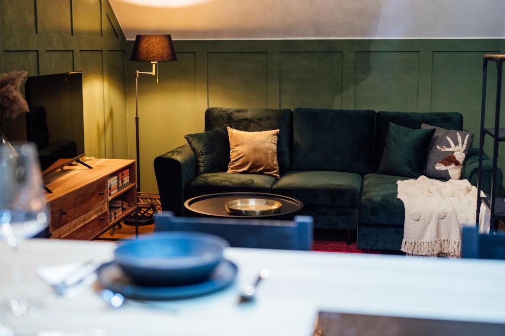 a living room with a couch and a table at Carpathian Apartment and private parking in Odorheiu Secuiesc