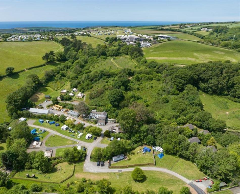 an aerial view of a park with the ocean at Willow Valley Glamping in Bude