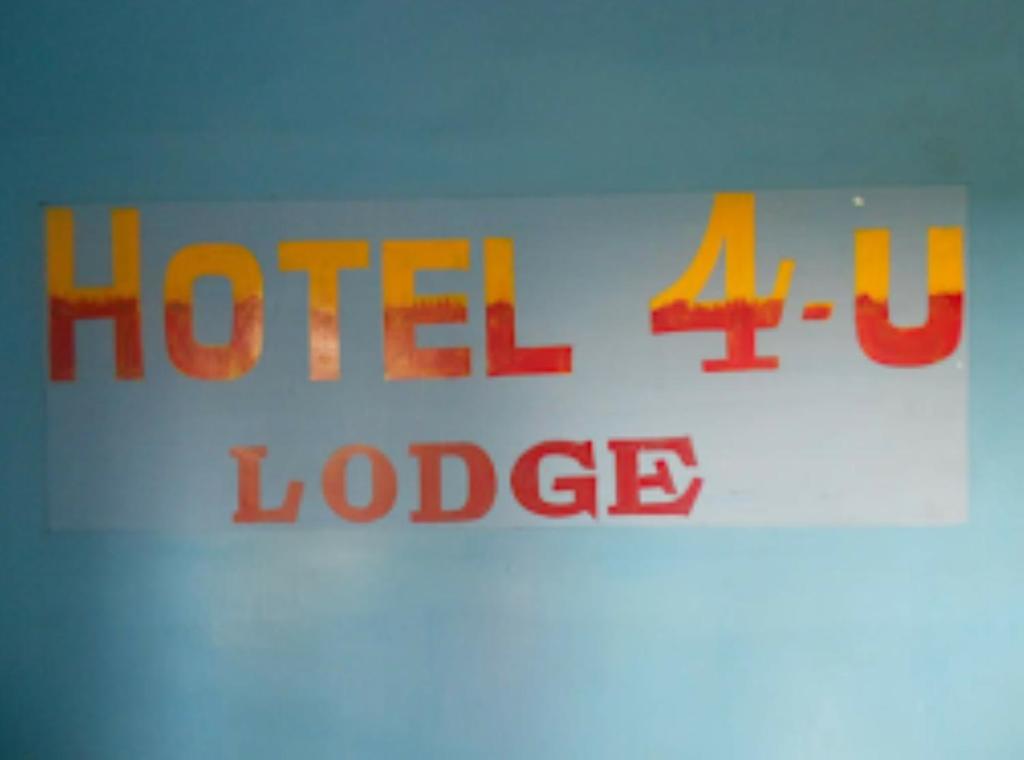 a close up of a sign with the words held up at Hotel 4-U Assam 