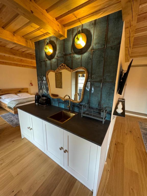 a bathroom with a sink and a mirror at Zajazd Hubert in Walim