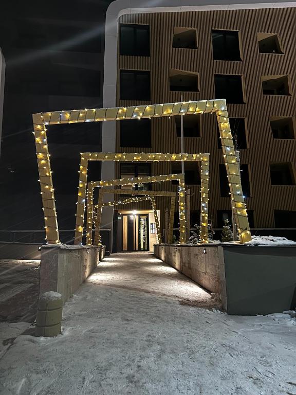 a building with a lit up arch with lights at Apartment Aurora in Bjelašnica