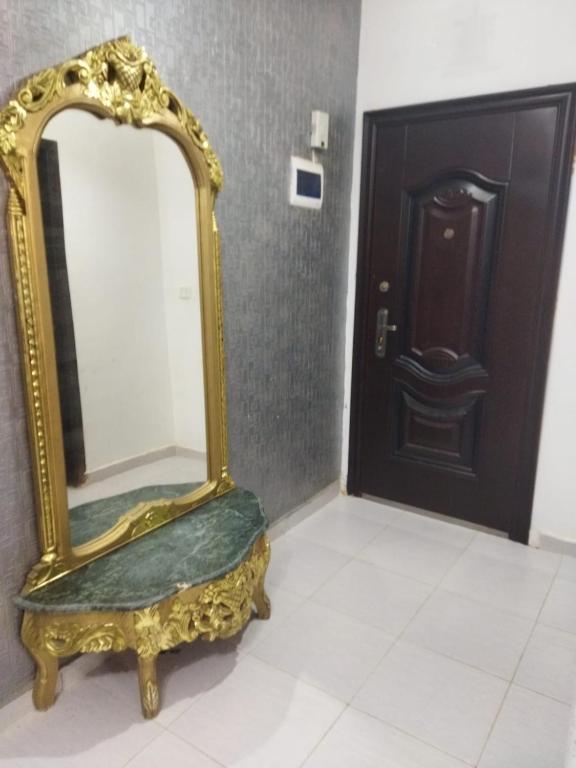 a gold mirror sitting on a white floor next to a door at Hurghada City Apartment1 in Hurghada