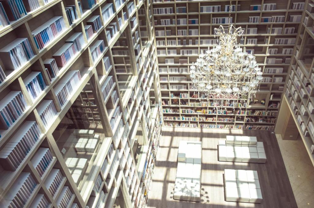 an overhead view of a library with a chandelier at The Gaia Hotel - Taipei in Taipei
