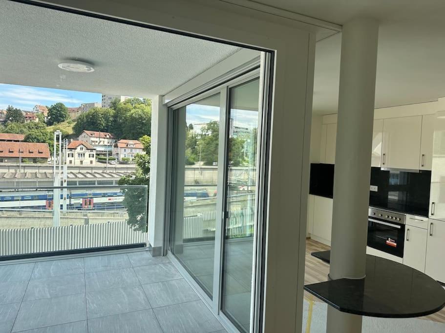 a kitchen with a large glass door to a balcony at Wohnung Neubau in Schaffhausen in Schaffhausen