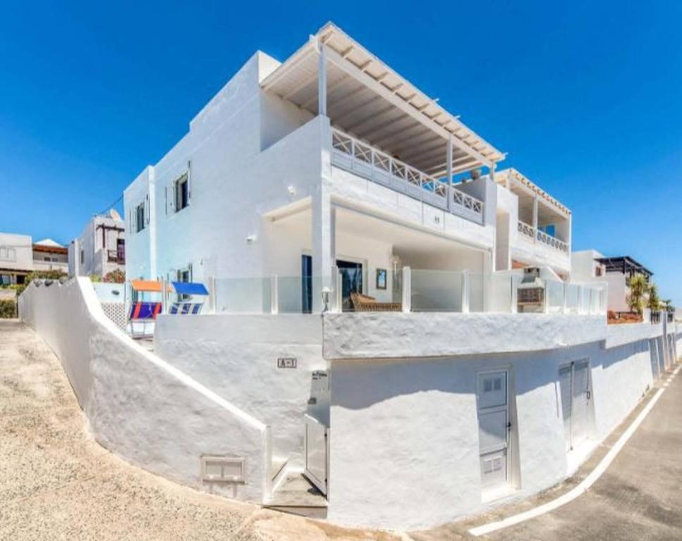 a large white house with a balcony at Villa Arcelia in Puerto del Carmen