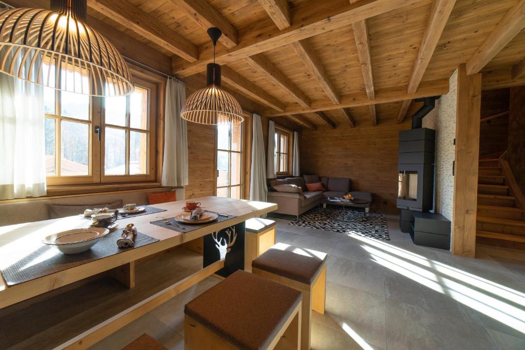 a large living room with a table and a couch at Chalet Chäserrugg in Wildhaus