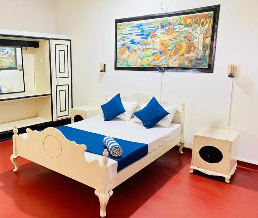 WatumullaにあるHotel Mount Lankaのベッドルーム1室(壁に絵画が描かれたベッド1台付)