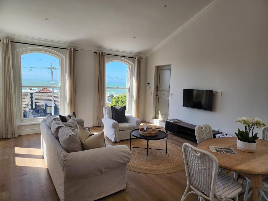 a living room with a couch and a table at Villa Moselle - St James in St. James