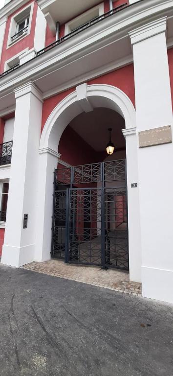 an entrance to a red and white building with a gate at Disney best location &amp; confortable 4 beds - All by feet in Serris