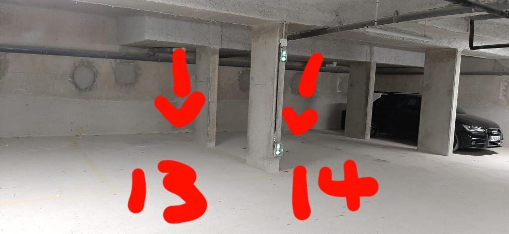 a parking garage with red writing on the wall at Disney best location &amp; confortable 4 beds - All by feet in Serris