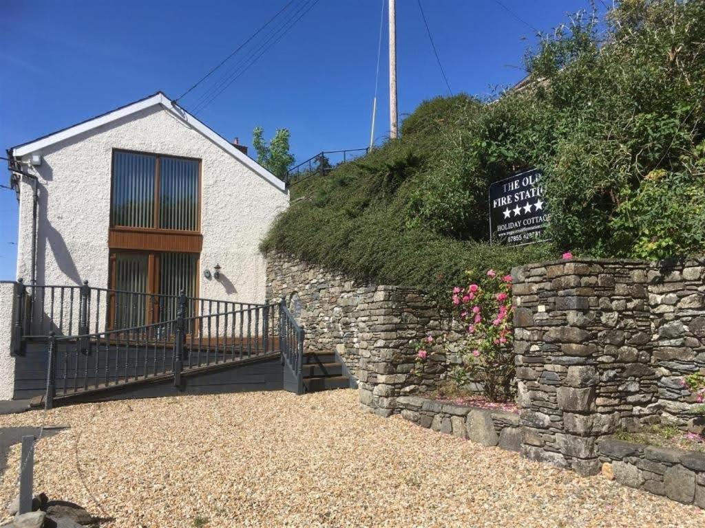 a brick building with a sign in front of it at The Old Fire Station in Tregaron