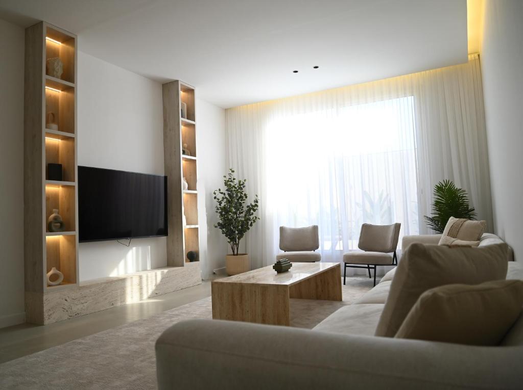 a living room with a couch and a tv at 2 Bedroom Apartment in Jeddah in Jeddah