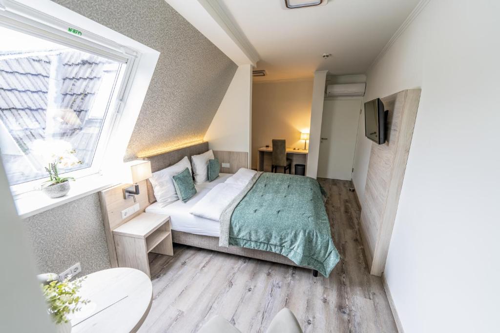 a small bedroom with a bed and a window at Hökis-Zimmervermietung 9 mit Küchenzeile in Brande-Hörnerkirchen