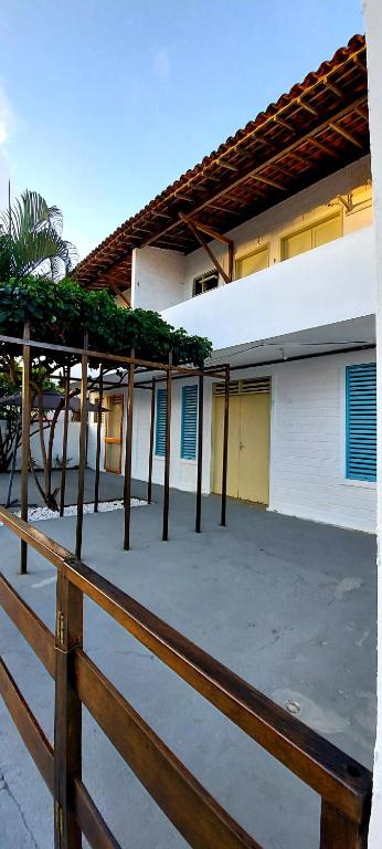 a wooden fence in front of a building at Pousada Esmeralda in Maragogi