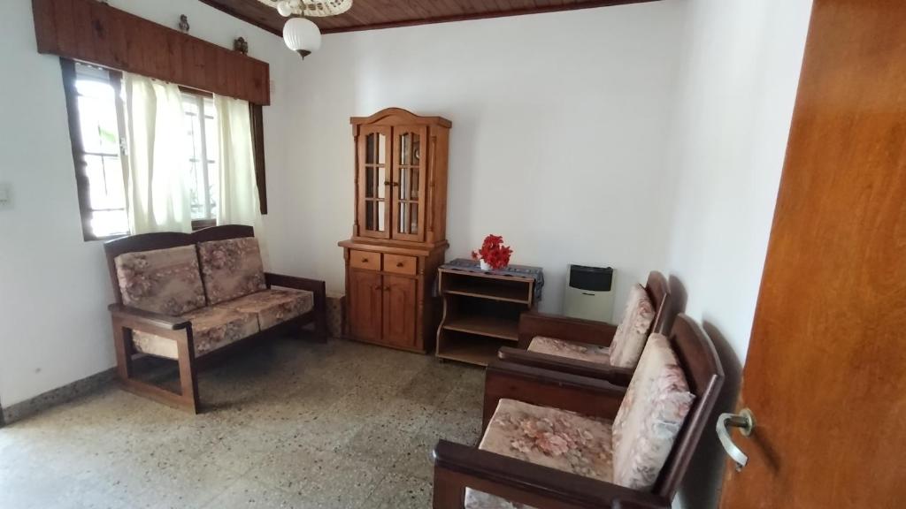 uma sala de estar com duas cadeiras e um armário em Lo de Silvia em Gualeguaychú