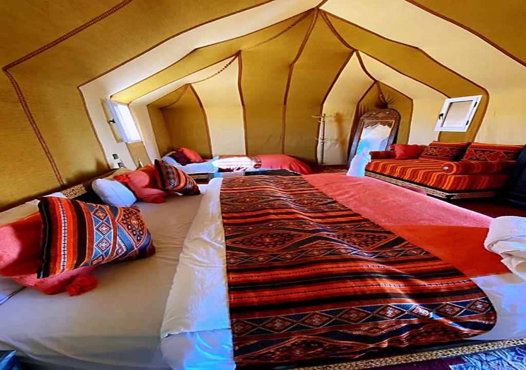 a bedroom with a large bed in a tent at Desert Sparrow Luxury Camp in Merzouga