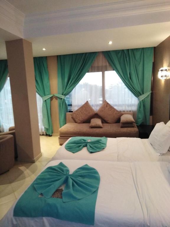 Postel nebo postele na pokoji v ubytování Suite Hotel Tilila