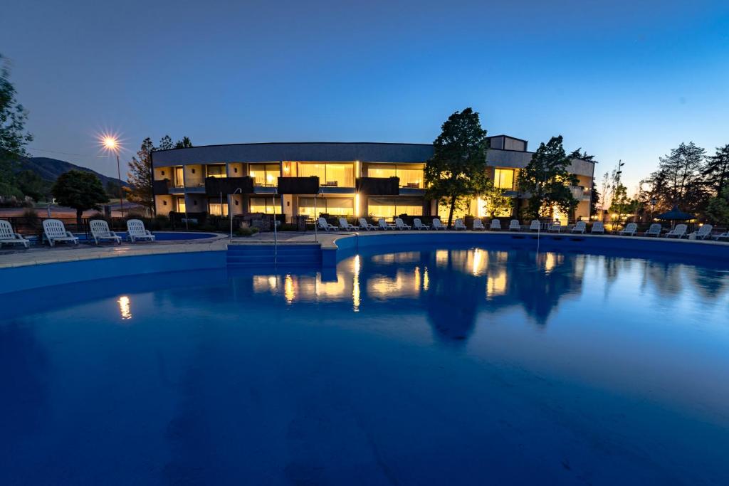 duży basen przed budynkiem w nocy w obiekcie Domingo Design Hotel w mieście Santa Rosa de Calamuchita