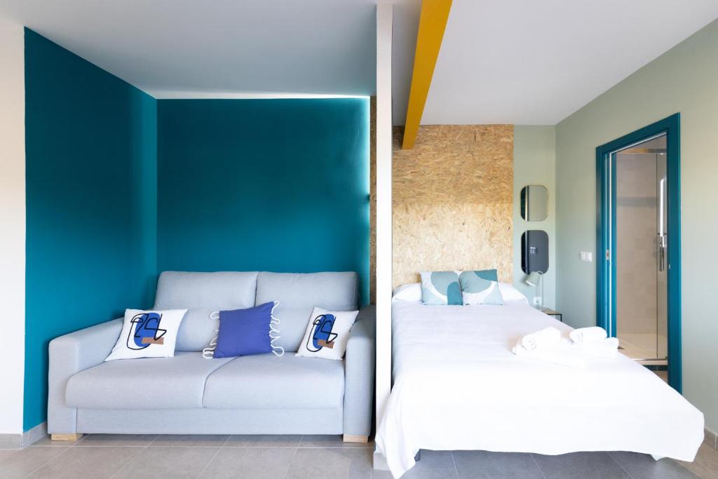a bedroom with two beds and a couch at Estudio moderno y acogedor en Madrid Rio nº 9 in Madrid
