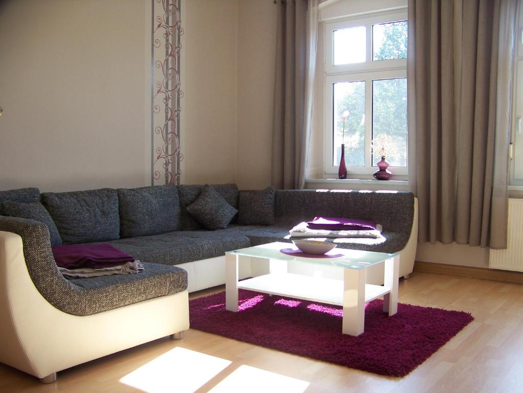 uma sala de estar com um sofá e uma mesa em Ferienwohnung Zöllner em Burg