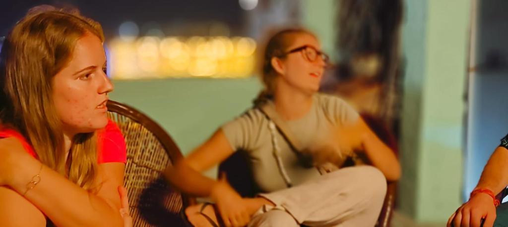 a group of young people sitting in chairs at Hotel Poonam Pushkar in Pushkar