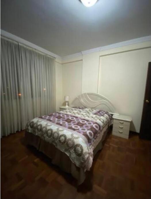 um quarto com uma cama num quarto em Cómoda habitación + parqueo em Cochabamba