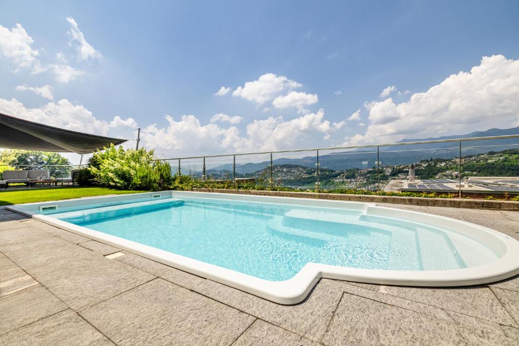 a swimming pool on the roof of a house at Villa Girandola with private, heated pool in Lugano