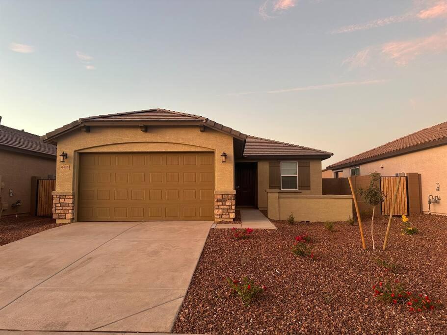 a house with a garage in a yard at *Home away from home* 5 min away from Stadium in Phoenix