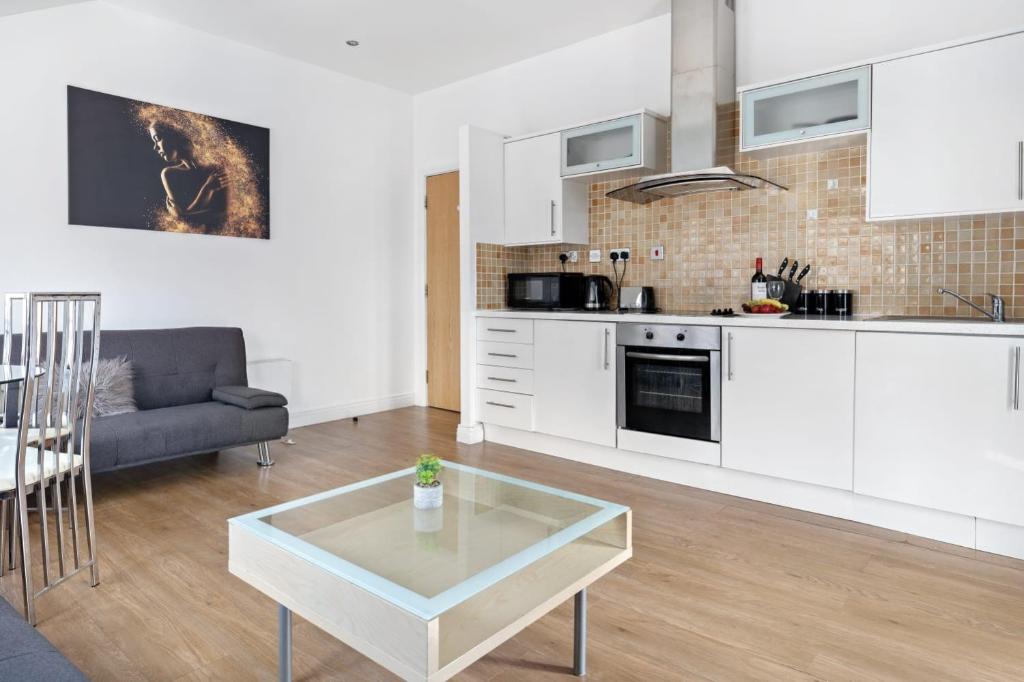 a kitchen and living room with a couch and a table at Heart of City Centre - Newcastle in Newcastle upon Tyne
