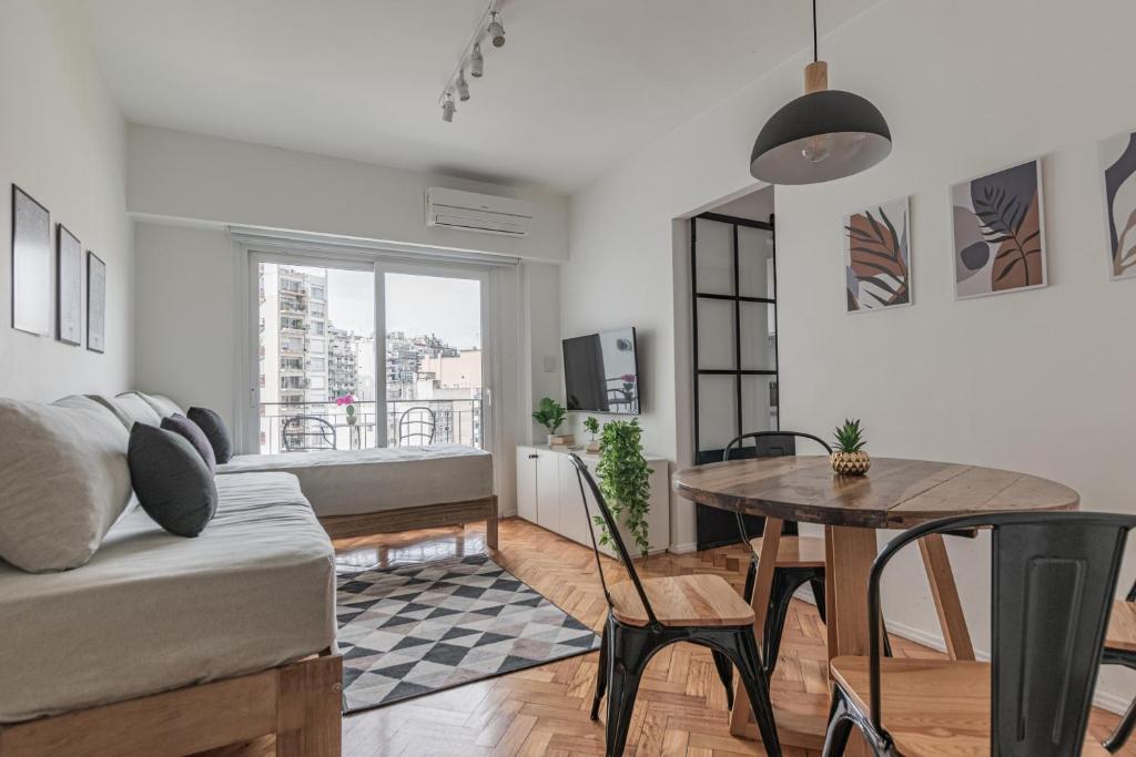 a living room with a couch and a table at Fliphaus Melo 2900 - 1 Bd Alto Palermo in Buenos Aires