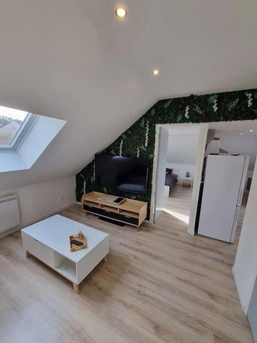 un salon avec un canapé et une table dans l'établissement Cosy appartement proche Disneyland, à Étampes-sur-Marne