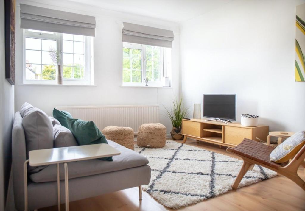 sala de estar con sofá y TV en GuestReady - Homely Leeds City Apartment Sleep 4, en Meanwood