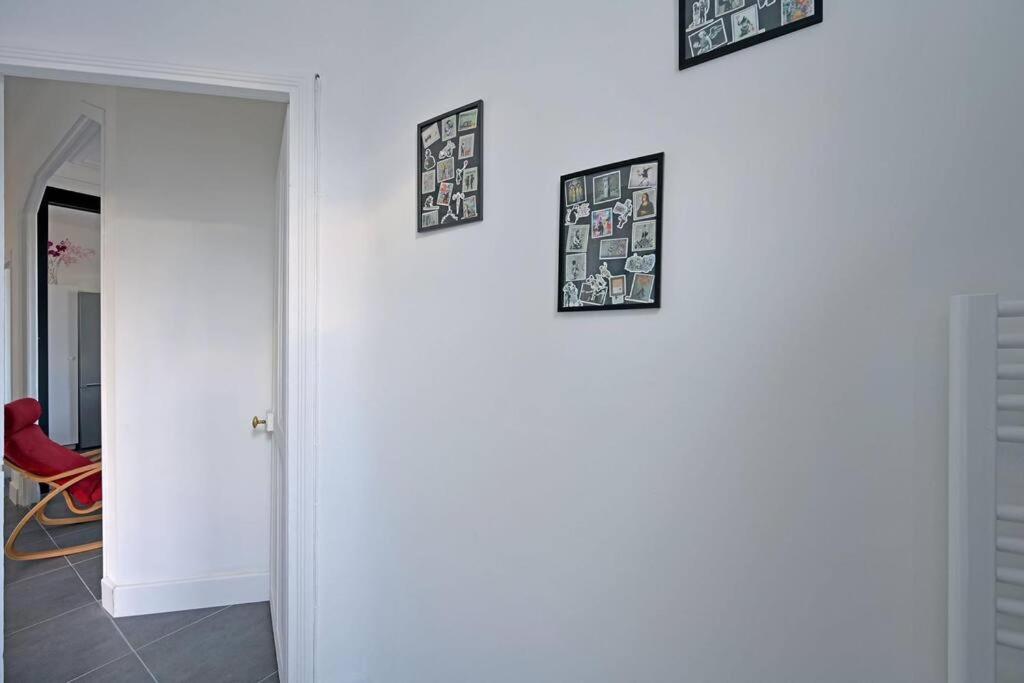 four framed pictures on a white wall in a room at The Rooftop - AC CLIM - Wi-Fi - Parking gratuit dans la rue in Avignon