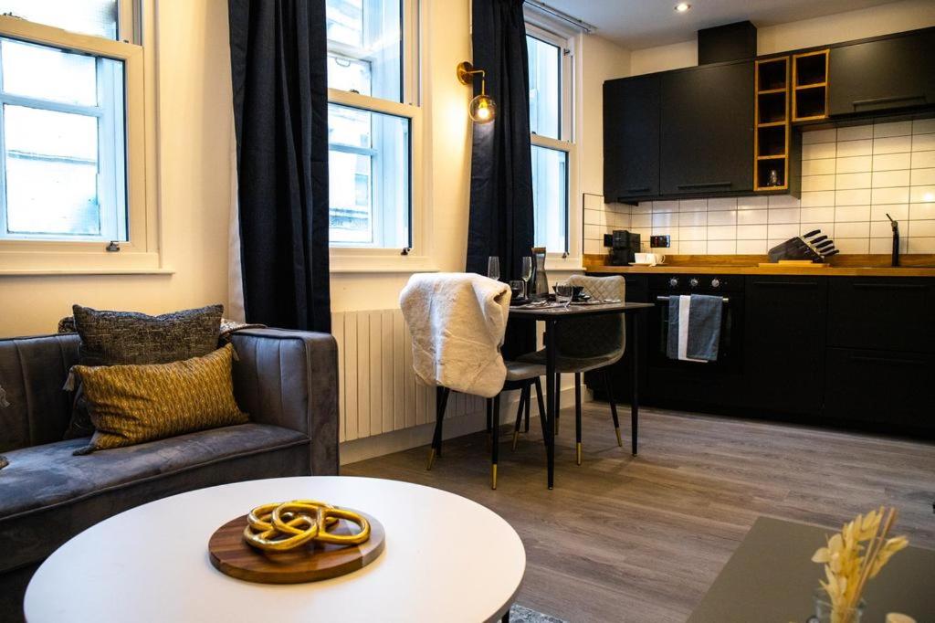 a living room with a couch and a table at Kirkgate Suites - Signature Suite in Leeds