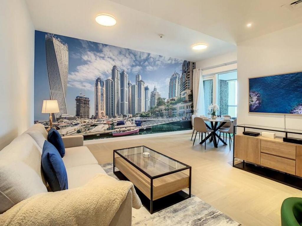 a living room with a large mural of a city at Key View - Sulafa Tower in Dubai