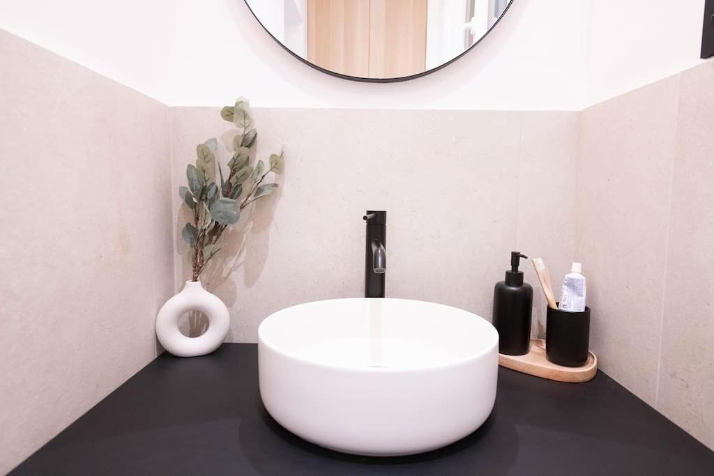 a bathroom with a white sink and a mirror at *Cozy flat-Latin Quarter in the heart of Paris* in Paris