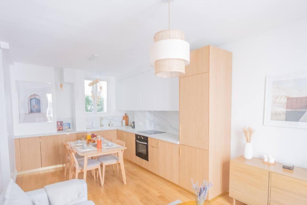 a kitchen with a table and a dining room at *Cozy flat-Latin Quarter in the heart of Paris* in Paris