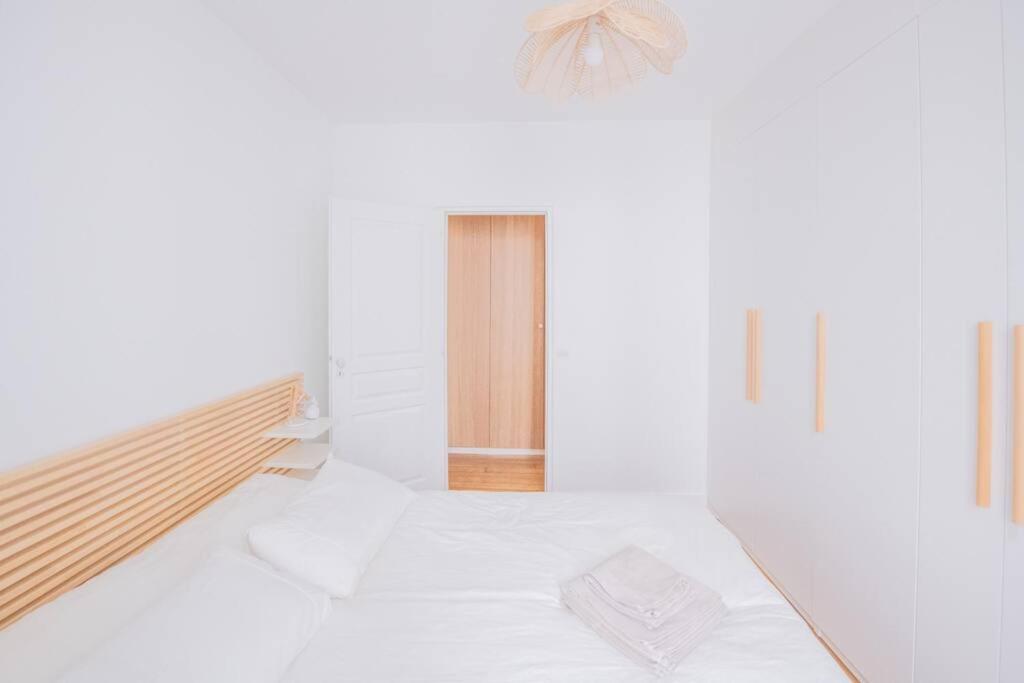 a room with white walls and a bed in it at *Cozy flat-Latin Quarter in the heart of Paris* in Paris