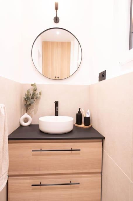a bathroom with a sink and a mirror at *Cozy flat-Latin Quarter in the heart of Paris* in Paris
