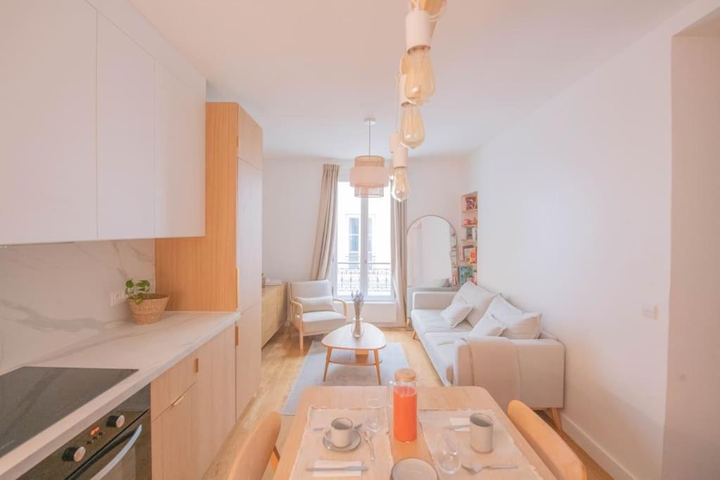 a kitchen with a table and a living room at *Cozy flat-Latin Quarter in the heart of Paris* in Paris
