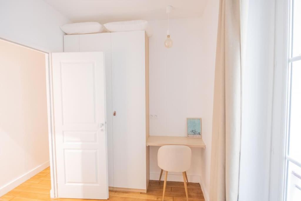 a white room with a chair and a desk at *Cozy flat-Latin Quarter in the heart of Paris* in Paris