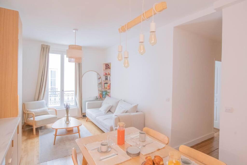 a living room with a white couch and a table at *Cozy flat-Latin Quarter in the heart of Paris* in Paris