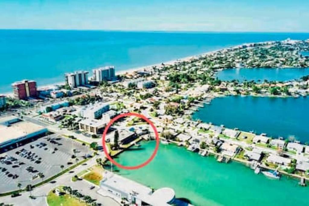 an aerial view of a marina with a red circle at Madeira Beach 2 bedroom Waterfront Condo With Dock in St. Pete Beach