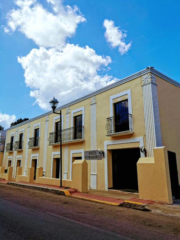 a large white building on the side of a street at Hotel Fundadores in Valladolid