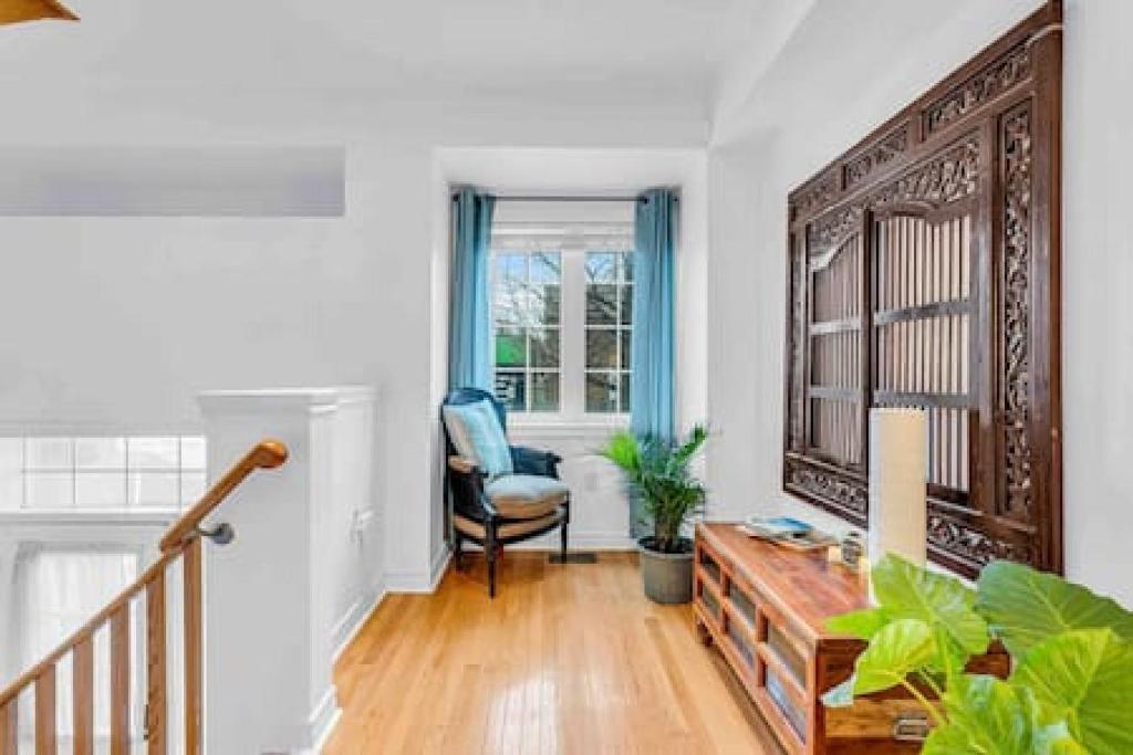 a living room with a table and a chair at Townhome by Subway and Downtown Toronto in Greektown in Toronto