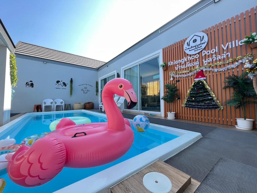 a pink inflatable pink flamingo in a swimming pool at Khiangkhoo Pool Villa ChiangKhan - เคียงคู่พูลวิลล่าเชียงคาน in Chiang Khan