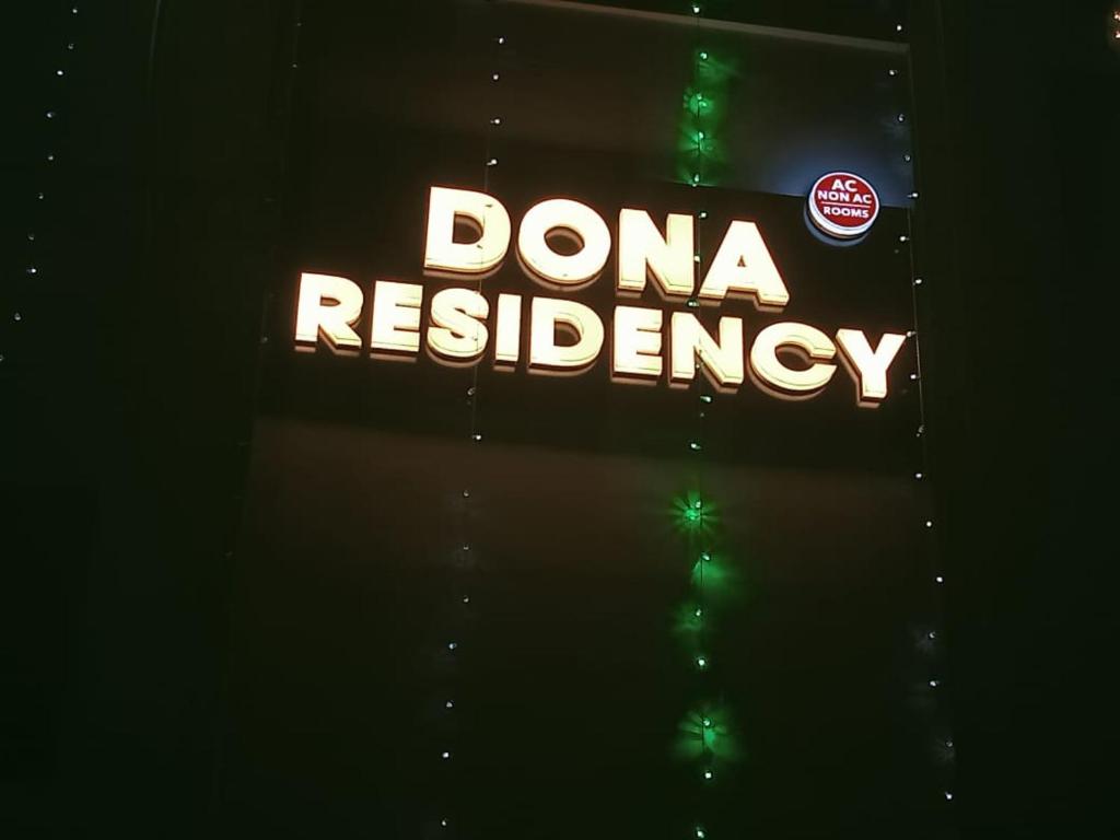 a sign that says danaresergy on a wall at Dona Residency in Nedumbassery